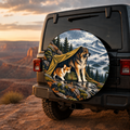 Mountain Camp Dogs in Autumn Spare Tire Cover featuring three loyal dogs sharing an autumn mountain campsite