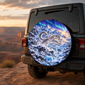 Snow Leopard Shimmering Glacier Spare Tire Cover featuring a snow leopard leaping across a shimmering glacier